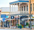 Historic storefronts line a charming small-town street.